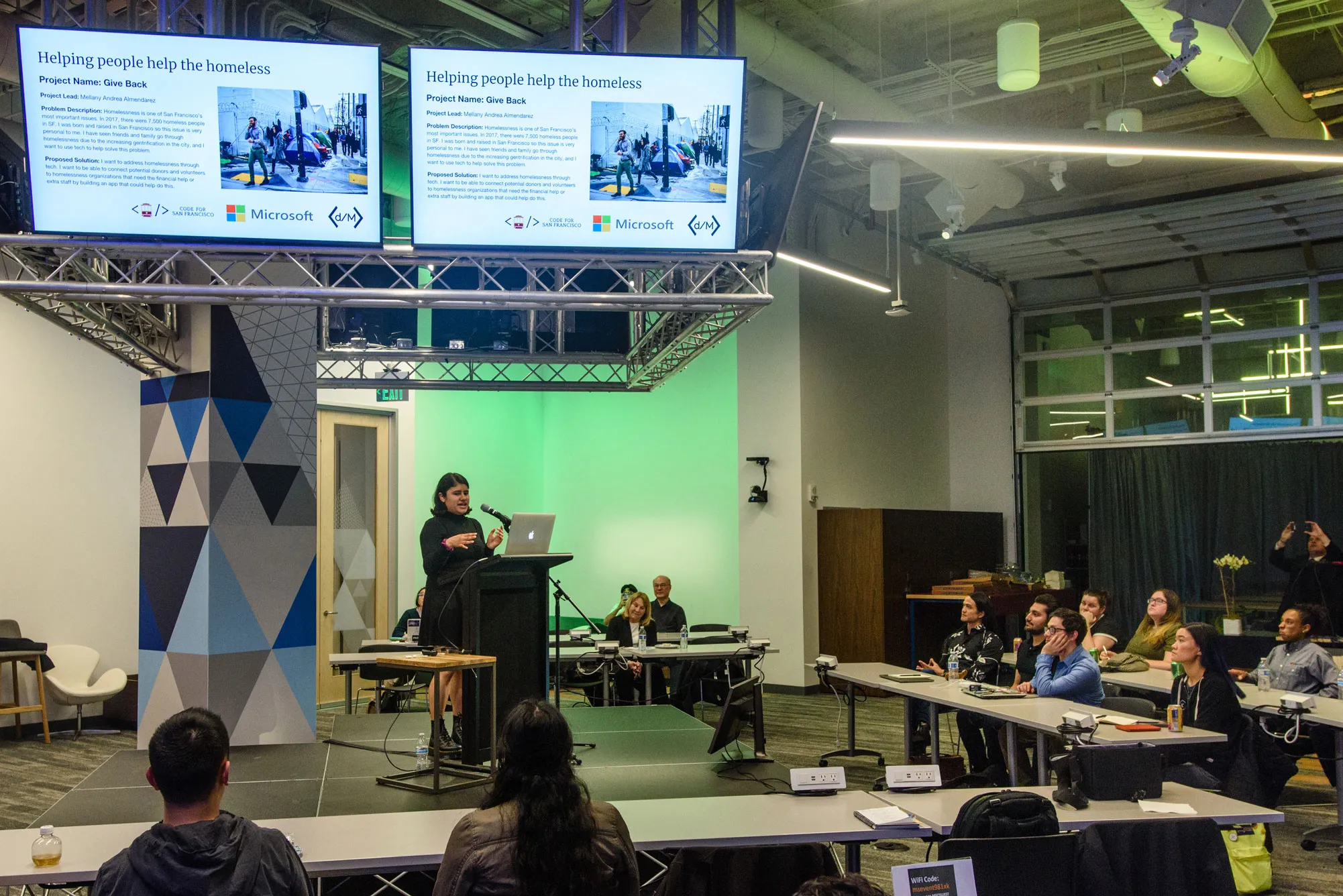 Mellany presents her Fellowship project at Microsoft's Reactor event space.